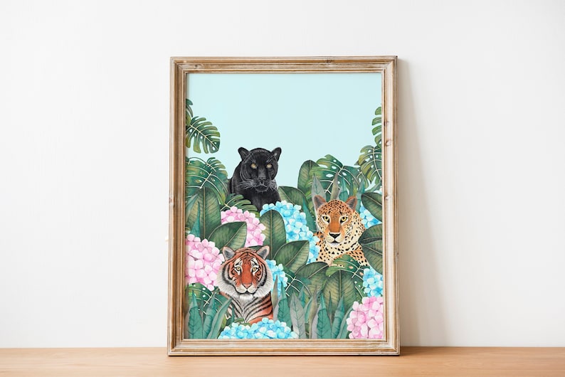 May include: A framed print featuring a black panther, a tiger, and a leopard peeking out from behind lush green foliage and pink and blue hydrangeas.
