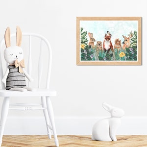 May include: A watercolor illustration of a fox, rabbit, deer, and squirrel surrounded by green leaves and yellow flowers. The animals are standing in a forest setting.
