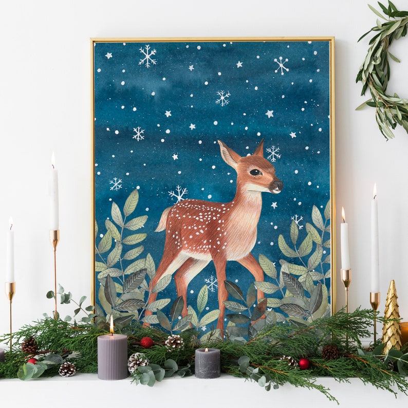 May include: A watercolor painting of a fawn standing in a snowy forest. The fawn is brown with white spots and has a white tail. The background is a dark blue with white snowflakes.