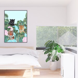May include: A framed print of three wild cats, a black panther, a leopard, and a tiger, surrounded by lush green foliage and pink and blue hydrangeas.