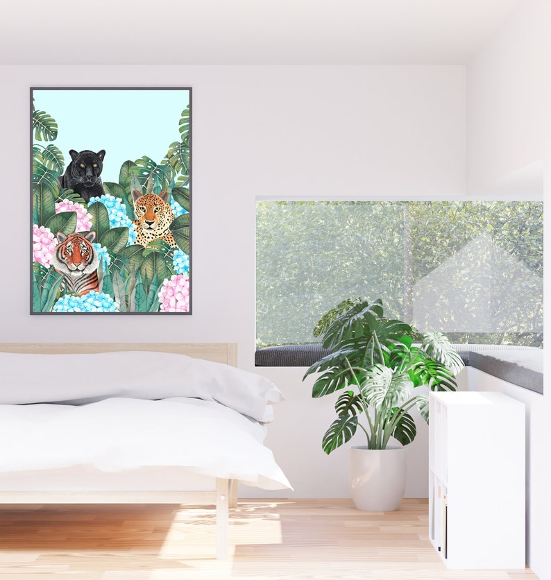 May include: A framed print of three wild cats, a black panther, a leopard, and a tiger, surrounded by lush green foliage and pink and blue hydrangeas.