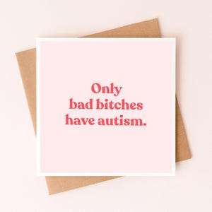 May include: A square greeting card with a light pink background and the text "Only bad bitches have autism." printed in a bold, red, sans-serif font. The card is positioned on top of a plain, light brown paper envelope.