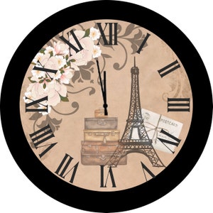 May include: Round wall clock with a black frame and a beige face featuring Roman numerals. The clock face includes a floral design, a stack of vintage suitcases, the Eiffel Tower, and a postcard.