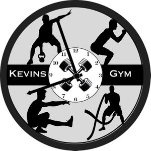 May include: Black and white clock with a gray background. The clock face features a dumbbell design with four dumbbells. The clock face also features the numbers 1 through 12. The clock is surrounded by a black frame. The words "KEVINS GYM" are printed on the clock face.