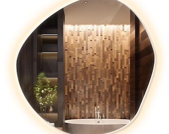 May include: A modern, oval-shaped bathroom mirror with a warm white LED light around the perimeter. The mirror reflects a bathroom with a wooden wall and a white bathtub.