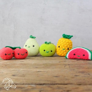 May include: A set of six crocheted fruit toys, including a pear, a pineapple, a watermelon, a lime, and two cherries. The toys are all brightly colored and have cute faces.