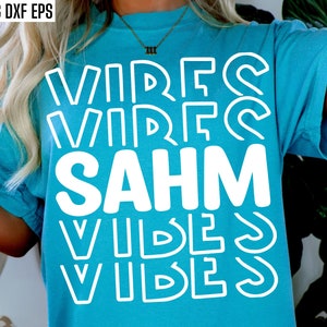 May include: A turquoise t-shirt with the text "VIBES SAHM VIBES" in white outlined letters.