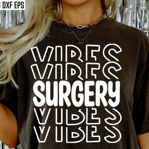 May include: A black t-shirt with white text that reads "VIBES SURGERY VIBES" in a layered, overlapping font style.
