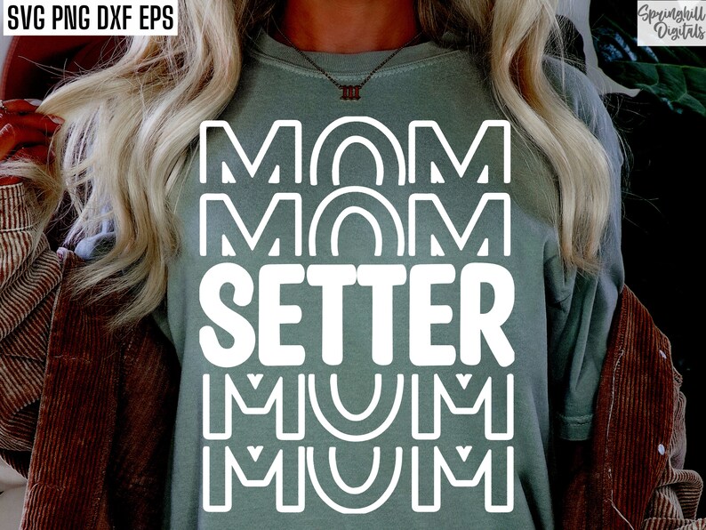 May include: A green t-shirt with the text "MOM MOM SETTER MUM MUM" in white outlined letters.