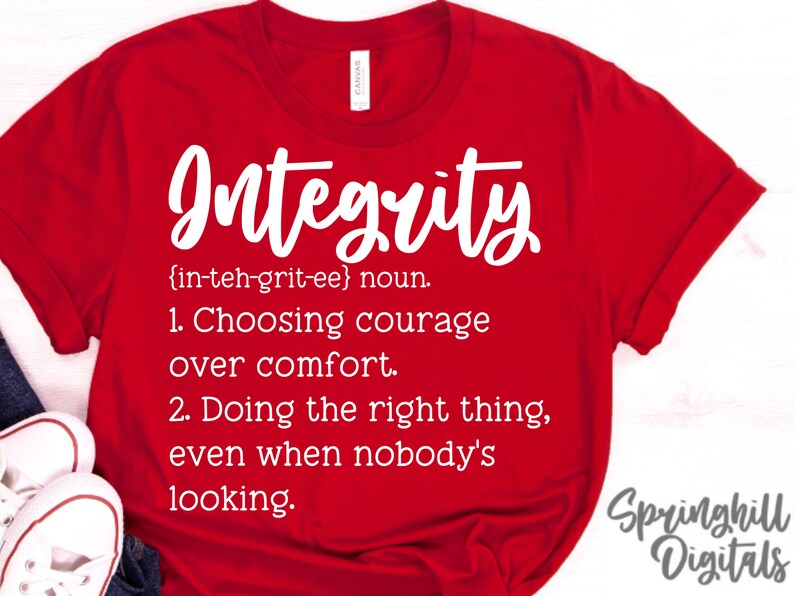 May include: Red t-shirt with white text that reads "Integrity {in-teh-grit-ee} noun. 1. Choosing courage over comfort. 2. Doing the right thing, even when nobody's looking." and "Springhill Digitals" in the bottom right corner.