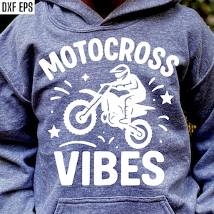 May include: A grey hoodie with a white graphic reading "MOTOCROSS VIBES". The design shows a motocross rider on a motorbike, with stars and lines. The hoodie has a front pocket and a hood.