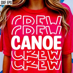 May include: Red t-shirt with white text that says "Canoe Crew" in a layered, stacked design.