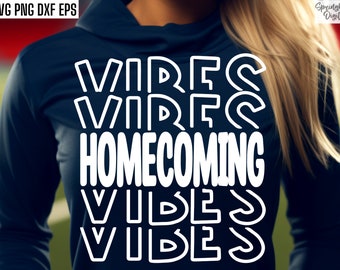 May include: A navy blue long-sleeved shirt with white text that reads "VIBES HOMECOMING VIBES". The text is in a bold, outlined font.