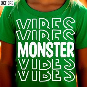 May include: A green t-shirt with the text "VIBES VIBES MONSTER VIBES VIBES" in white outlined letters.
