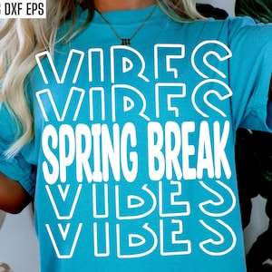 May include: A turquoise blue t-shirt with the text "Spring Break Vibes" in white outlined letters. The text is repeated four times, with the letters stacked on top of each other.