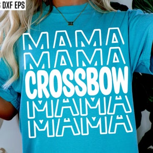 May include: A turquoise t-shirt with the words "MAMA CROSSBOW MAMA MAMA" in bold white letters. The shirt has short sleeves and a relaxed fit. The top left corner has the text "SVG PNG DXF EPS".