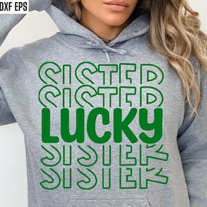 May include: A gray hoodie with the text "SISTER" repeated four times in a green outline, with the word "LUCKY" in green in the center.