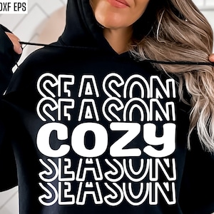 May include: A black hoodie with white text that reads "Season Season Cozy Season Season".