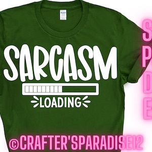 May include: A green t-shirt with the text "Sarcasm Loading" in white. The text is displayed with a progress bar underneath. The text "@Crafter's Paradise12" is at the bottom of the shirt.