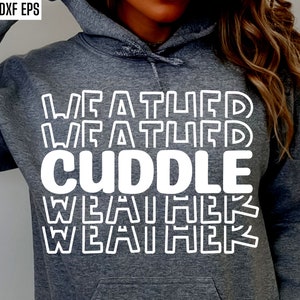 May include: A gray hoodie with white text that reads "Weather CUDDLE Weather" in a stacked, repeating pattern.