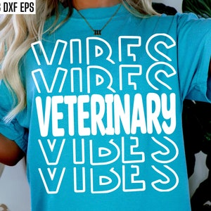 May include: A turquoise t-shirt with white text that reads "VIBES VETERINARY VIBES". The text is in a retro, layered font style.