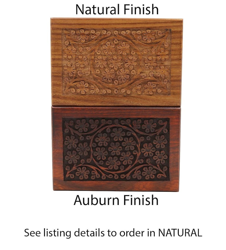 May include: Two wooden boxes with floral carvings. The top box has a natural finish, while the bottom box has an auburn finish. The boxes are rectangular and feature detailed floral patterns on their lids. The text "Natural Finish" and "Auburn Finish" are displayed.