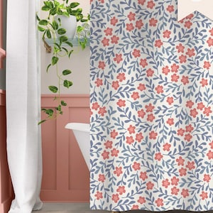 May include: A white shower curtain with a floral pattern featuring pink flowers and blue leaves. The shower curtain is in a bathroom with a white bathtub and pink walls. The text "DARLING HOUSE bed + bath" is visible in the bottom left corner of the image.