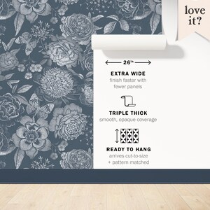 May include: A blue floral wallpaper with a white floral pattern. The wallpaper is 26 inches wide and is described as extra wide, triple thick, and ready to hang. The wallpaper is shown on a wall with a wooden floor.