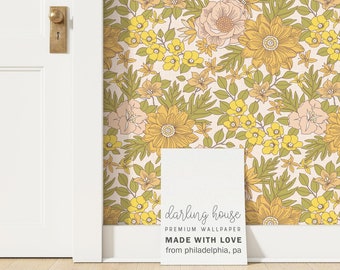 May include: A white card with the text "darling house PREMIUM WALLPAPER MADE WITH LOVE from philadelphia, pa" on a background of yellow and green floral wallpaper.