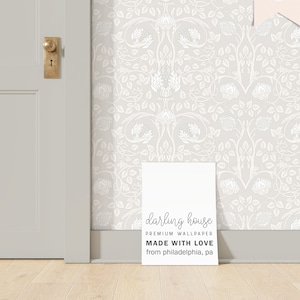 May include: A white poster with the text "darling house PREMIUM WALLPAPER MADE WITH LOVE from philadelphia, pa" on a light gray background with a white floral pattern.