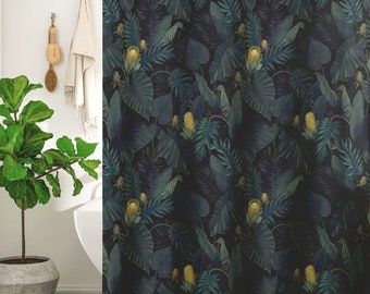 May include: A dark blue shower curtain with a tropical leaf pattern. The leaves are in shades of green and yellow, and the background is a dark blue. The shower curtain is made of a soft, water-resistant fabric. The text "Darling House bed + bath" is visible in the bottom left corner of the image.