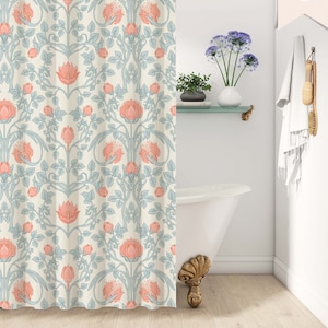 May include: A shower curtain with a floral pattern in shades of pink, blue, and white. The pattern features stylized flowers and leaves on a cream background. The text "lightweight + fast dry polyester poplin" is printed at the bottom of the image. The text "darling house PREMIUM TEXTILES" is printed in the bottom right corner.
