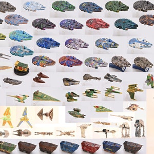 May include: A collection of Star Wars spaceship models made from wood and painted in various colors. The models include the Millennium Falcon, X-Wing, TIE Fighter, and AT-AT.