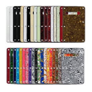 May include: A set of 30 guitar pickguards in various colors and patterns, including black, white, red, blue, green, and brown. The pickguards are made of plastic and have a smooth, glossy finish.