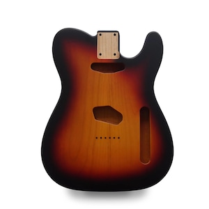 Könnte beinhalten: Ein Gitarrenkorpus mit Sunburst-Finish, mit schwarzem Rand, der in ein rötlich-braunes und dann ein helleres braunes Zentrum übergeht. Es hat Aussparungen für Tonabnehmer, Bedienelemente und einen Hals, mit vorgebohrten Löchern für Saiten.