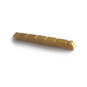 May include: A gold-colored metal guitar bridge saddle with six grooves for string placement.