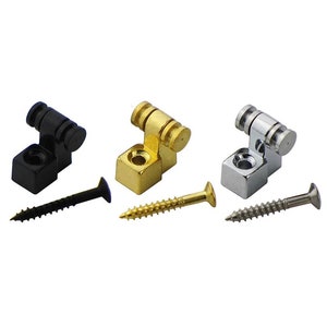 May include: Three guitar bridge saddles, one black, one gold, and one chrome, with screws.