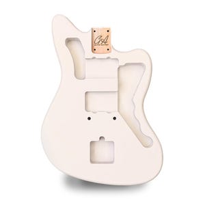 May include: A white guitar body with cutouts for pickups, controls, and a tremolo system. A small wooden piece with the text "GA Guitar Anatomy" is attached to the top. The body has a smooth, matte finish.