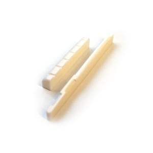 May include: White plastic guitar bridge saddle and a separate white plastic bridge pin. The saddle has grooves for the strings.