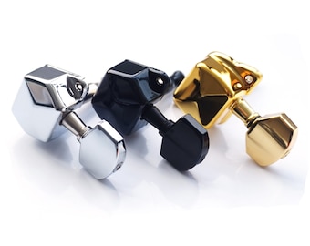 May include: Three guitar tuning pegs in silver, black, and gold finishes. Each peg has a hexagonal shape with a rounded top.