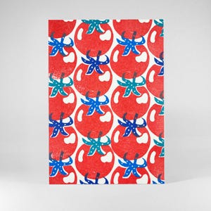 May include: A rectangular card with a repeating pattern of red tomatoes, each with blue and teal details. The tomatoes have white highlights and are arranged in a grid, creating a bright and cheerful design.