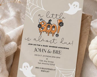 May include: A rectangular baby shower invitation card on a brown envelope featuring the text 'a little BOO is almost due!' with orange pumpkin graphics, white ghost illustrations, and spider web patterns. The card includes event details for John and Bre.
