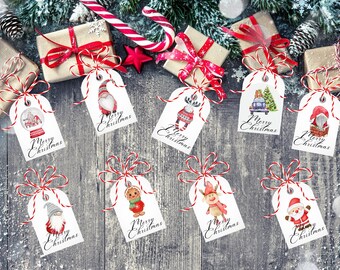 May include: A set of nine white rectangular gift tags featuring various Christmas-themed watercolor illustrations including gnomes, a reindeer, a gingerbread person, and Santa Claus, each with red and white twine and Merry Christmas text.