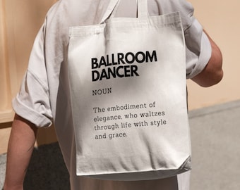 May include: White tote bag with black text that reads "BALLROOM DANCER NOUN The embodiment of elegance, who waltzes through life with style and grace."