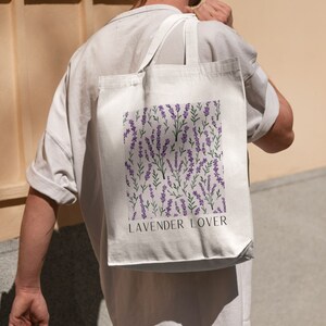 May include: A white tote bag with a purple lavender floral pattern and the text "Lavender Lover" printed on the front.