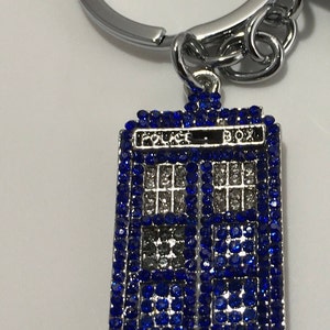 British tv space doctor keychains: little blue Dalek, red Dalek, Tardis sparkle