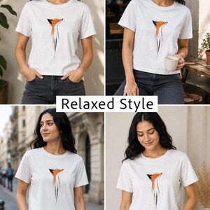 May include: A white short-sleeve t-shirt featuring a stylised orange and black fox head graphic on the chest. The design includes abstract brushstroke details extending downwards from the fox. The text Relaxed Style is centred in the image.