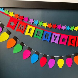 May include: A colorful felt garland with light bulbs and stars, spelling out "Merry Christmas".