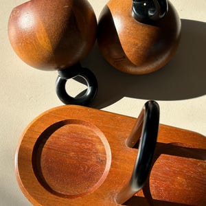 Vintage Bodum Ballboy salt and pepper mills resting on original teak stand with black metal handle, Danish modern kitchenware.
