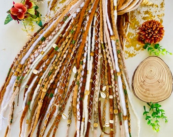 May include: A collection of handmade dreadlocks in various shades of brown, white, and tan. The dreads are adorned with beads, shells, and decorative stitching. The dreadlocks are styled in a bundle, showcasing the intricate details and textures.